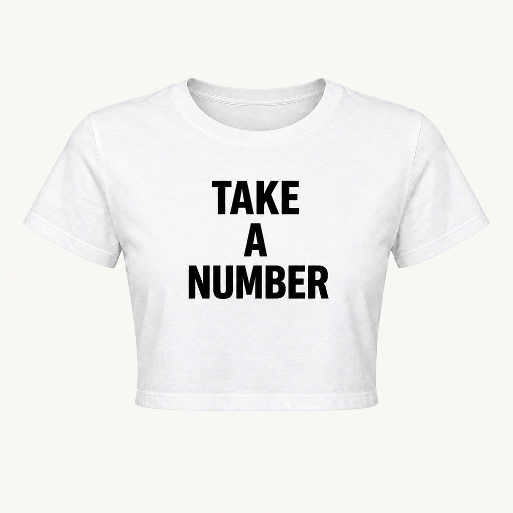 White crop top with TAKE, A, NUMBER in three lines of black block lettering