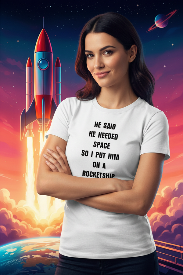 Woman wearing HE SAID HE NEEDED SPACE SO I PUT HIM ON A ROCKETSHIP t-shirt with rocket in background