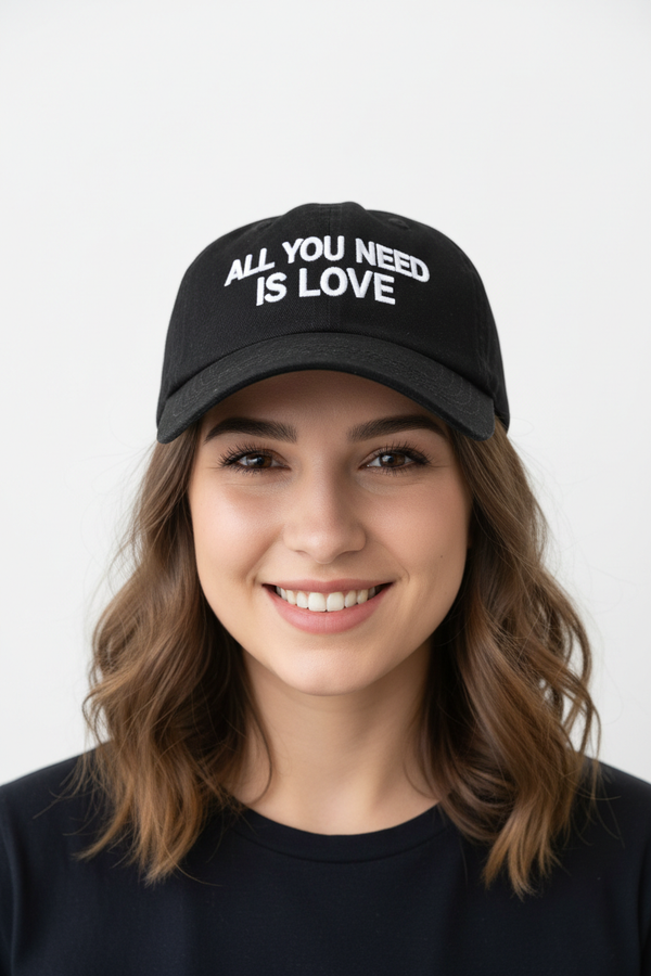 Cute young woman wearing All You Need Is Love cap